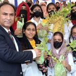 Commissioner Sargodha Mohammad Ajmal Bhatti distributing saplings among the students during the Plant for Pakistan campaign.