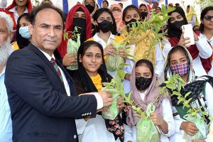 Commissioner Sargodha Mohammad Ajmal Bhatti distributing saplings among the students during the Plant for Pakistan campaign.