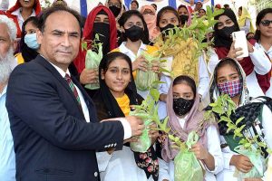 Commissioner Sargodha Mohammad Ajmal Bhatti distributing saplings among the students during the Plant for Pakistan campaign. 