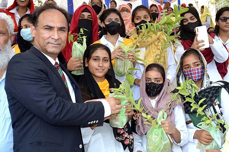 Commissioner Sargodha Mohammad Ajmal Bhatti distributing saplings among the students during the Plant for Pakistan campaign.