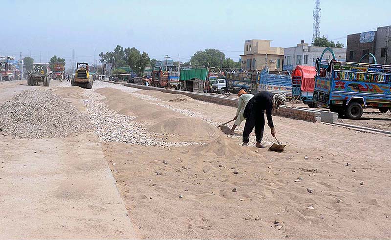 Laborers are busy in ground leveling work at Bahawalpur Road during the development work in the city