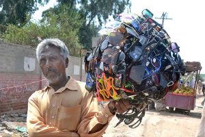 A vendor displaying Sunglasses to attract customers while shuttling on the road