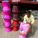 A worker busy in making traditional chair (moorah) at his workplace near Sargodha road