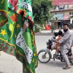 A family on motorbike saw Eid Milad-un-Nabi related stuff for selling at roadside in the Federal Capital