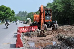 Heavy machinery being used for expansion work of Club Road during development work in the Federal Capital