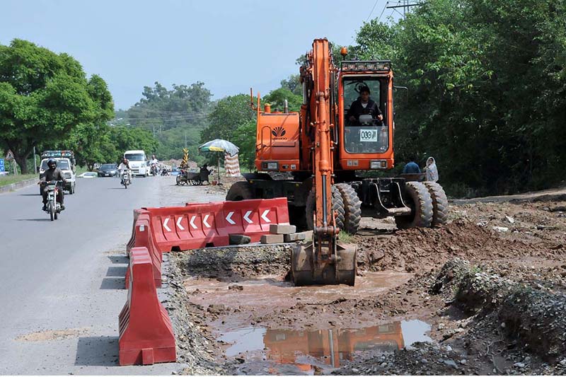 Heavy machinery being used for expansion work of Club Road during development work in the Federal Capital