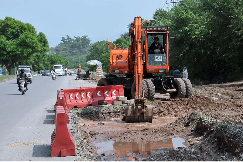 Heavy machinery being used for expansion work of Club Road during development work in the Federal Capital