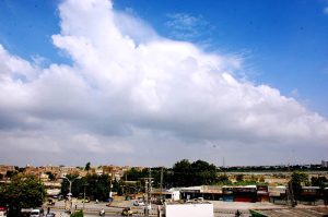 A beautiful view clouds hovering over the sky in the city.