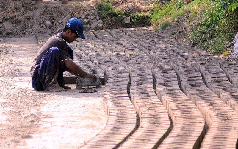Labourers busy in making bricks at a local brick kiln