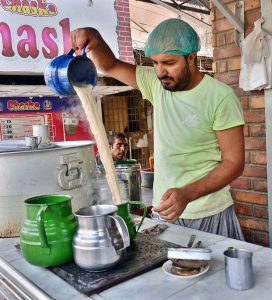  A vendor preparing tea for customers at his hotel. 