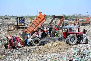 SSWMB workers busy dumping garbage in dumping garbage area at Latifabad