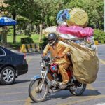 A motorcyclist on the way loaded with valuables after collecting from different points in Federal Capital.