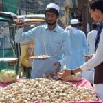 Vendor selling and displaying garlic on his handcart at Hashtnagri Chowk.