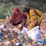 Gypsy girls searching valuables from the heap of garbage