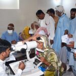 A doctor examines a patient's eyes after rising eye infections at LRBT Secondary Eye Hospital.