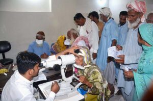 A doctor examines a patient's eyes after rising eye infections at LRBT Secondary Eye Hospital.