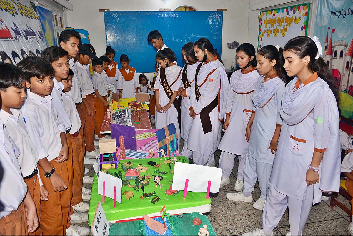 Students viewing models related Defence day exhibition at RC school.