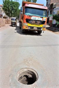  A view of open sewerage main hole on the road at Latifabad. 