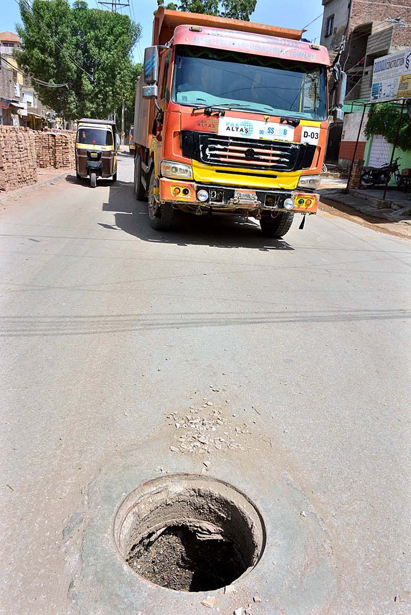 A view of open sewerage main hole on the road at Latifabad.