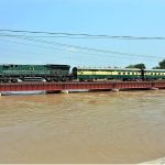 A beautiful view of train passing over a bridge on the water canal at Tando Yousuf area.
