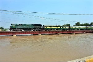 A beautiful view of train passing over a bridge on the water canal at Tando Yousuf area. 