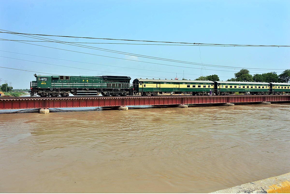A beautiful view of train passing over a bridge on the water canal at Tando Yousuf area.
