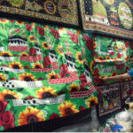 A vendor arranging and displaying Eid Milad-un-Nabi (PBUH) related stuff to attract the customersat his shop