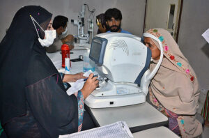 A doctor examines a patient's eyes after rising eye infections at LRBT Secondary Eye Hospital.