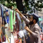 A vendor displaying beads (tasbih) to attract the customers at his roadside setup
