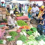 People selecting and purchasing different vegetables from vendor at Latifabad