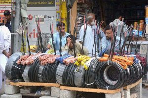 Vendor waiting for customers to sell electric wires at Kali Bari area. 