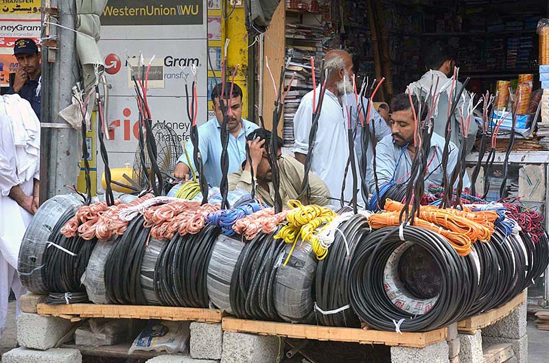 Vendor waiting for customers to sell electric wires at Kali Bari area.