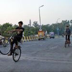 A youngster riding bicycle on one wheel at Katchary Flyover.