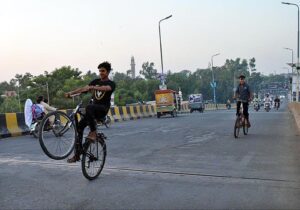  A youngster riding bicycle on one wheel at Katchary Flyover.
