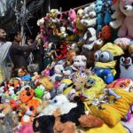 A father is buying old toys for his daughter in the Provincial city