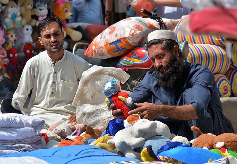 A vendor displaying beads (tasbih) to attract the customers at his roadside setup