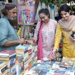 Women selecting old books on a roadside stall in the Provincial Capital