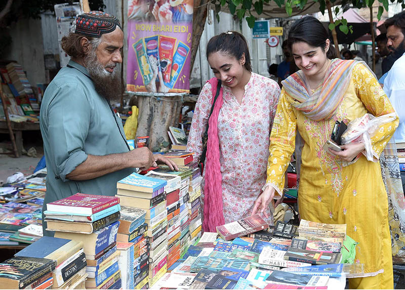 Women selecting old books on a roadside stall in the Provincial Capital