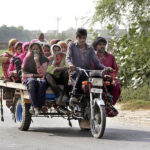 Ladies traveling on the tricycle motorcycle heading toward their destination