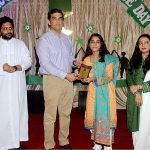 Deputy Commissioner Umar Jahangir giving shield to student during the ceremony at La Salle Higher Secondary School
