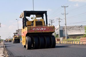 Laborers busy construction work of Lahore road during development work in the city.