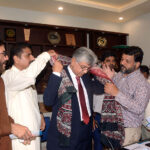 Caretaker Federal Minister for Information and Broadcasting Murtaza Solangi being presented Ajrak by Karachi Press Club office bearers at Karachi Press Club
