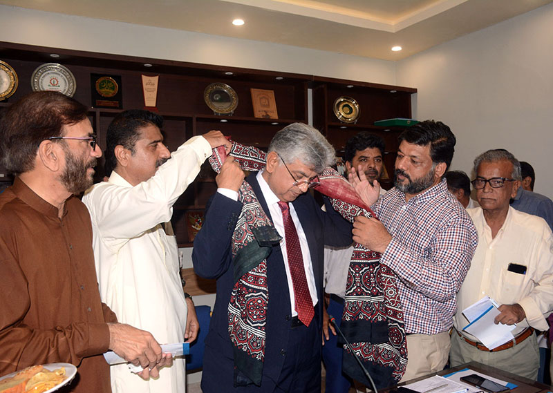 Caretaker Federal Minister for Information and Broadcasting Murtaza Solangi being presented Ajrak by Karachi Press Club office bearers at Karachi Press Club