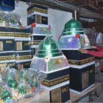 A vendor arranging and displaying Eid Milad-un-Nabi (PBUH) related stuff to attract the customers in the Provincial city.