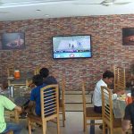 People are watching Pakistan India match in a cafeteria