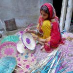 Girl making handmade traditional stuff for selling purpose at his workplace