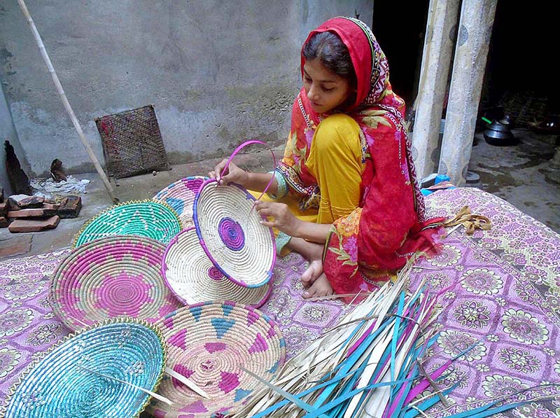 Girl making handmade traditional stuff for selling purpose at his workplace