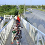 Motorcyclists crossing from the bridge at Srinagar Highway.