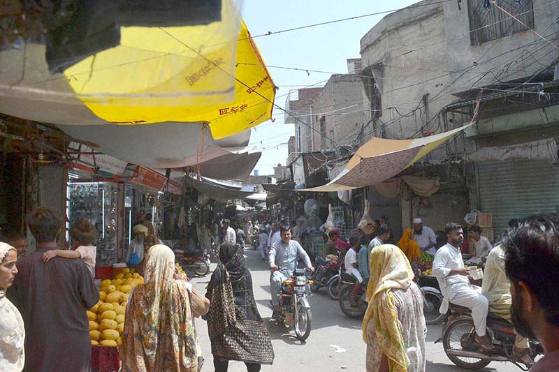 Customers are busy in purchasing stuff from vendors at a Local Market.