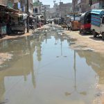 A view of sewerage water accumulated on the road at unit number 11 Latifabad